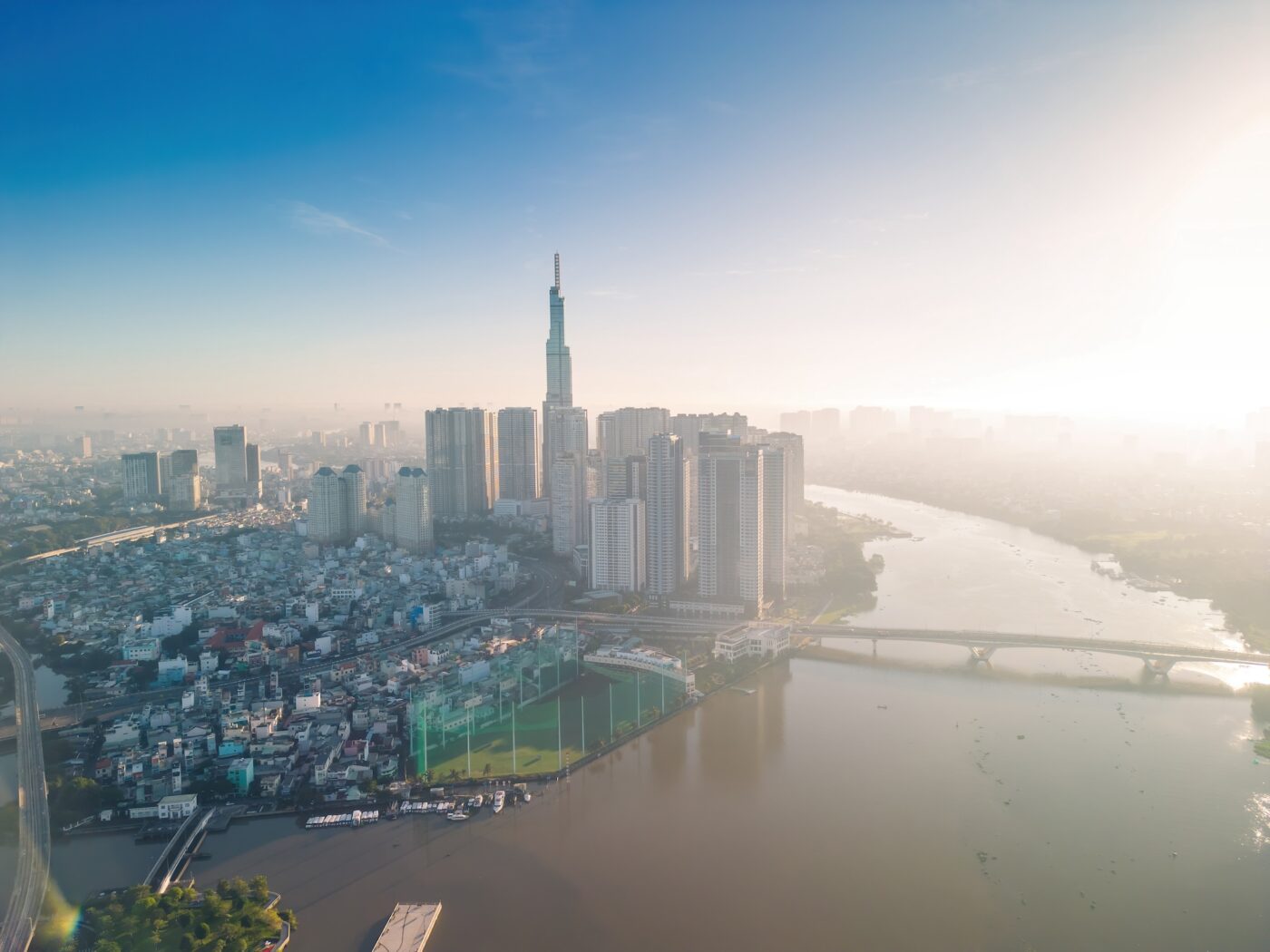 Aerial View Of Ho Chi Minh City Skyline And Skyscrapers On Saigon River, Center Of Heart Business At Downtown. Morning View. Far Away Is Landmark 81 Skyscraper