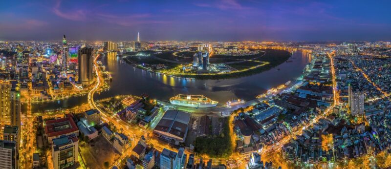 Top View Aerial Photo From Flying Drone Of A Ho Chi Minh City With Development Buildings, Transportation, Energy Power Infrastructure. Financial And Business Centers In Developed Vietnam.